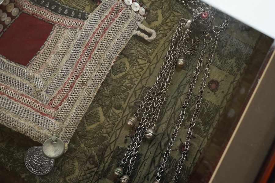 A framed Omani tribe wedding veil, 45 x 62cm. Condition - good